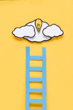 cardboard ladder with light bulb and clouds on yellow background, ideas concept clipart