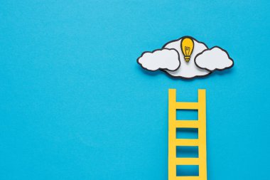 cardboard ladder, light bulb and clouds with copy space on blue background, ideas concept clipart