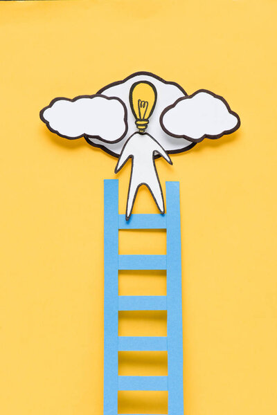 top view of cardboard man with light bulb head climbing ladder on yellow background, ideas concept