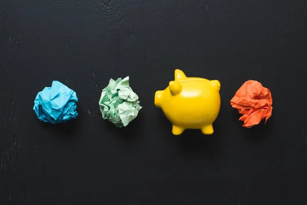 Top View Colorful Crumpled Paper Balls Piggy Bank Black Background Stock Photo