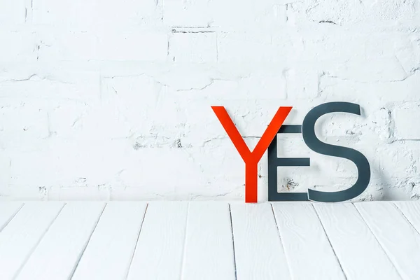 Yes Lettering Decorative Red Black Letters Wooden Table White Brick — Stock Photo, Image