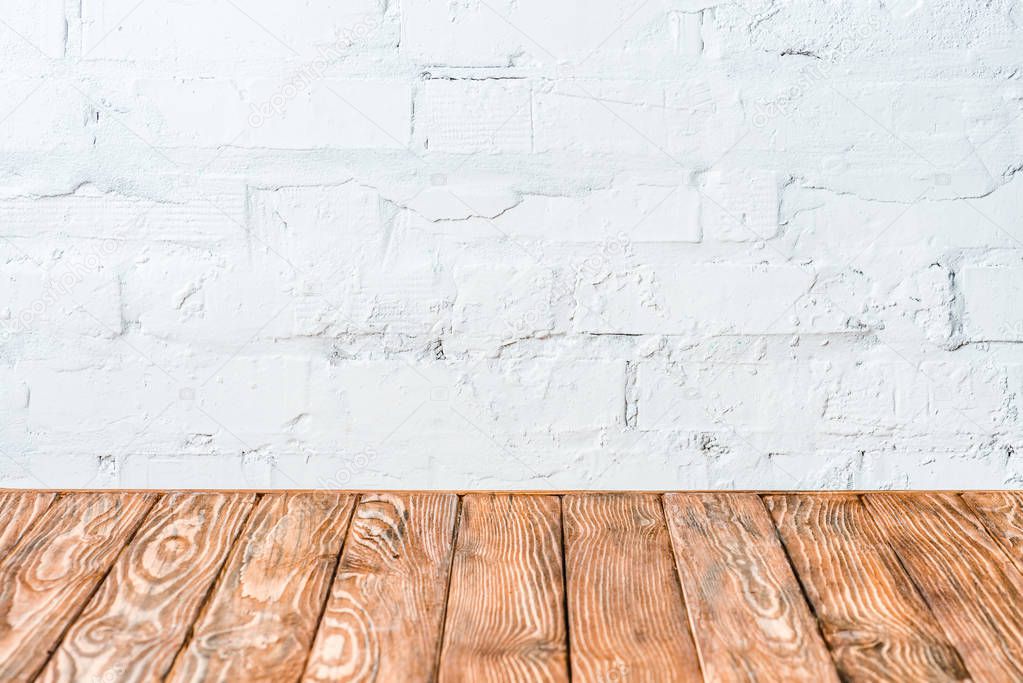 white brick wall and rustic wooden table