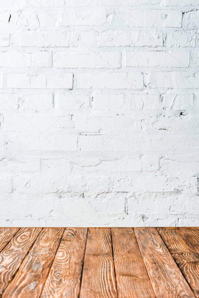 white brick wall and wooden table