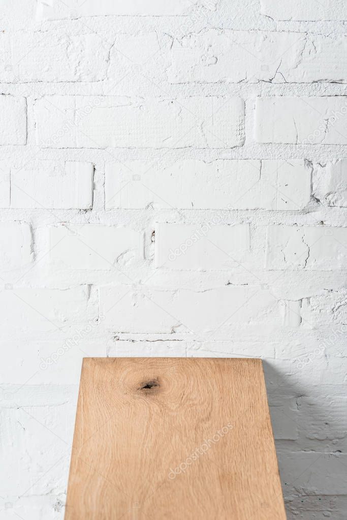 textured wooden board and white brick wall