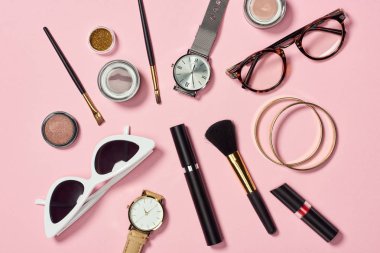 Top view of watches, lipstick, glasses, sunglasses, eyeshadow, blush, cosmetic brushes, bracelets and mascara  clipart