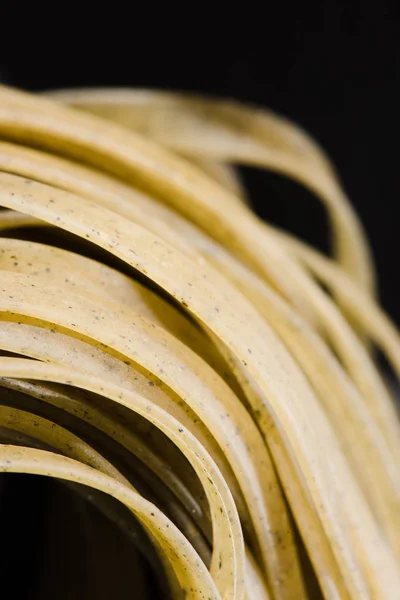 Close-up shot of delicious raw spaghetti on black — Stock Photo