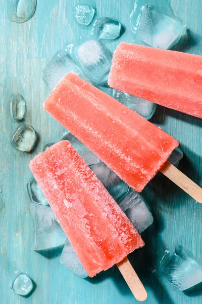 Sweet red fruit Popsicles on wooden background — Stock Photo