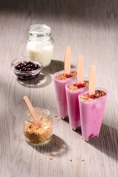 Sweet fruit Popsicles in molds with cooking ingredients on wooden background — Stock Photo