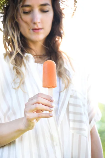 Jeune femme tenant délicieux dessert popsicle — Photo de stock