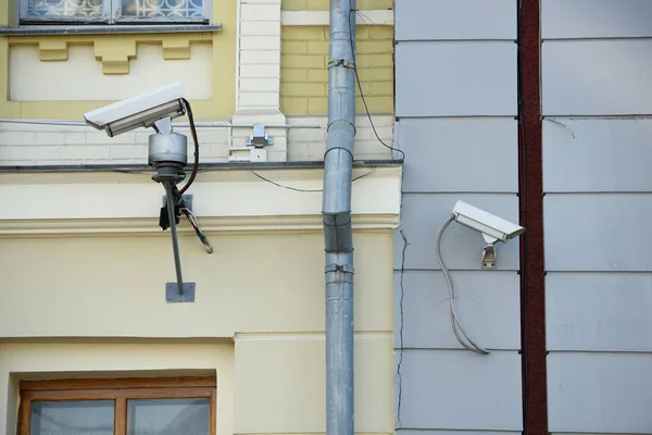 Close up view of security cameras on different buildings facades — Stock Photo