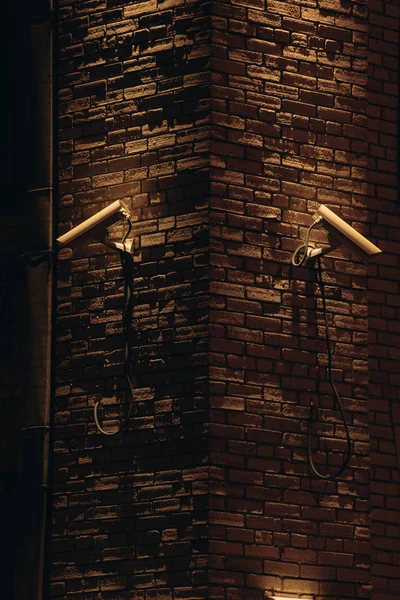 Close up view of security cameras on building facade at night — Stock Photo