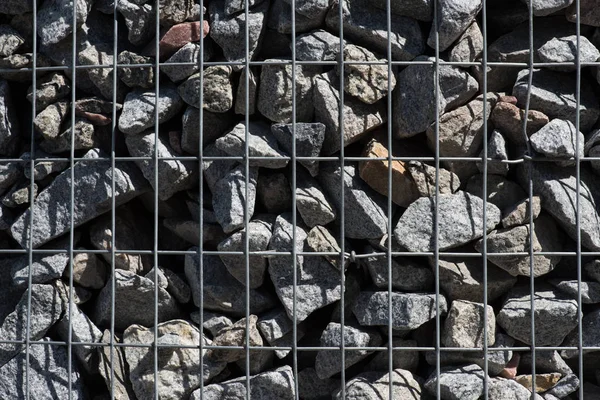 Full frame image of metal cage covered stones background — Stock Photo