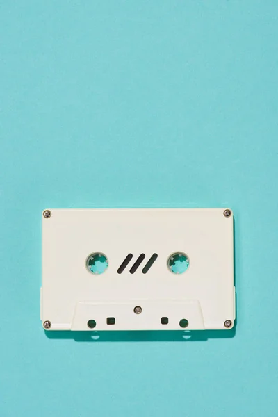 Top view of white retro audio cassette isolated on blue — Stock Photo