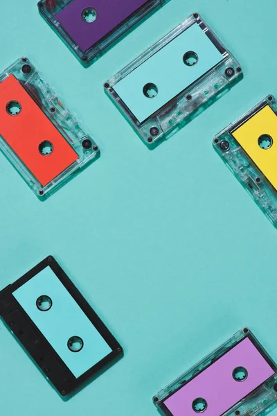 Flat lay with arranged colorful retro audio cassettes isolated on blue — Stock Photo