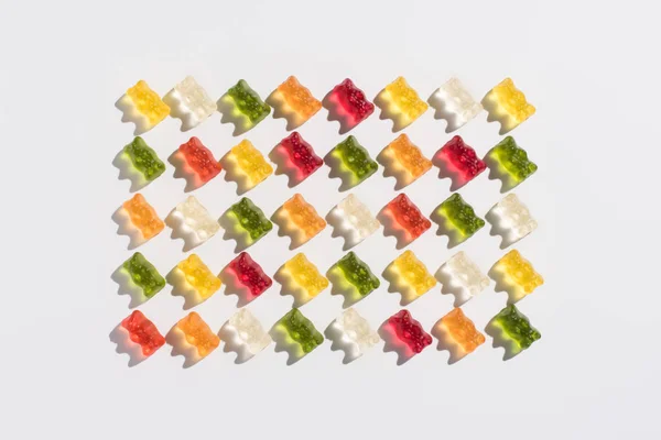 Top view of colorful gummy bears pattern on white — Stock Photo