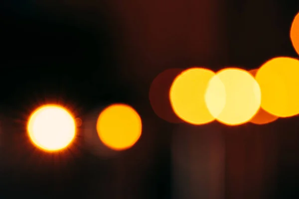 Close up view of colorful bokeh lights on dark background — Stock Photo