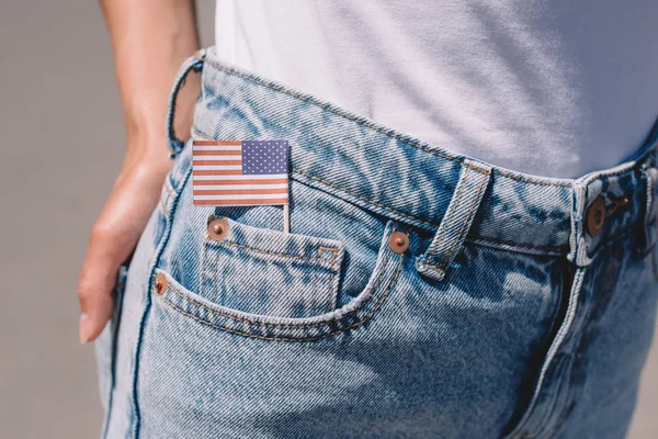 Partial view of woman in jeans with american flagpole in pocket, americas independence day holiday concept — Stock Photo
