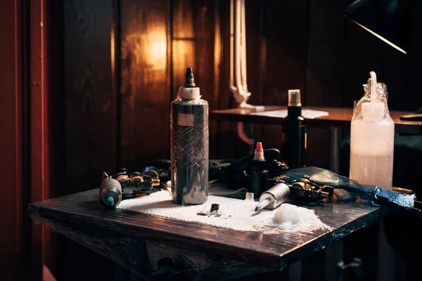 Close up view of arranged tattoo machines and paint at tattoo salon — Stock Photo