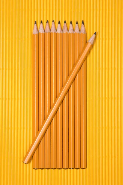 Elevated view of graphite pencils placed in row on yellow — Stock Photo