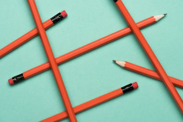 Top view of arranged graphite pencils with erasers on green — Stock Photo