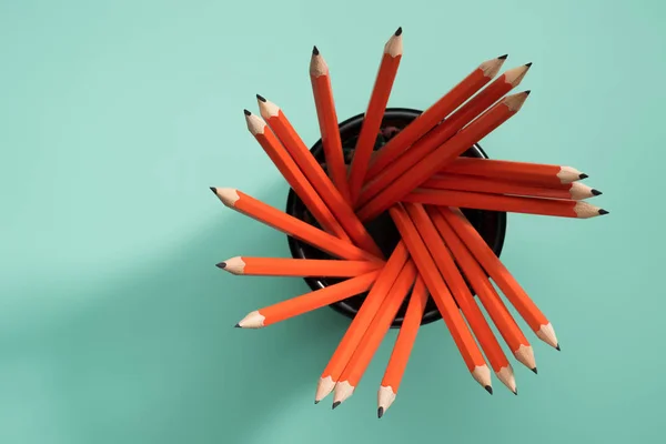 Elevated view of graphite pencils in desk organizer on green — Stock Photo