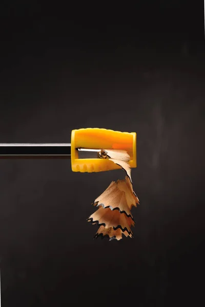 Close up of pencil shavings from sharpener on black — Stock Photo