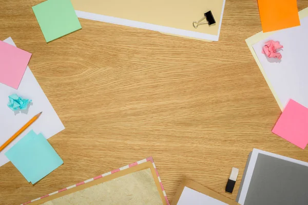 Top view of table with blank papers and stick it notes with stationery supplies on table — Stock Photo