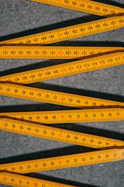 Elevated view of collapsible meter on grey surface — Stock Photo