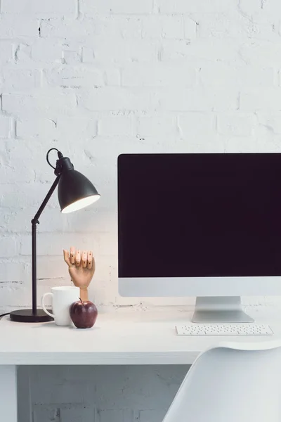 Computer and ripe apple on table in modern office — Stock Photo