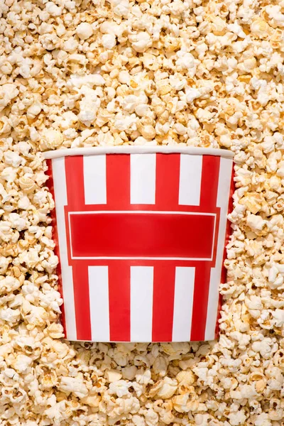 Flat lay with disposable bucket and crunchy popcorn — Stock Photo