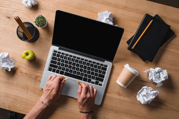 Cropped shot of businessman breaking pencil at workplace with laptop and crumpled papers — Stock Photo