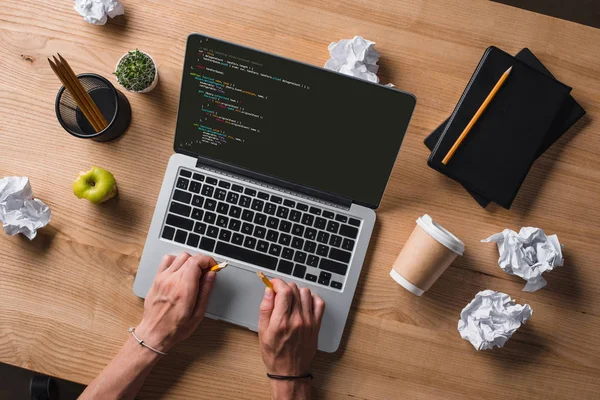 Cropped shot of businessman breaking pencil while looking at code on screen at workplace — Stock Photo