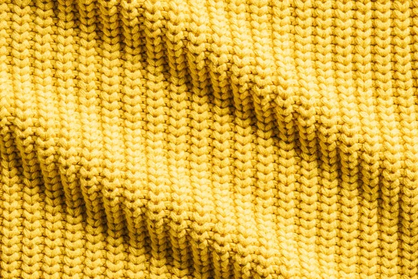 Full frame image of wavy yellow woolen fabric background — Stock Photo