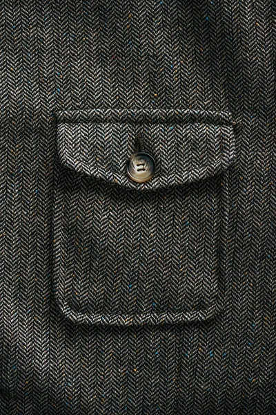 Close up view of grey woolen pocket with button — Stock Photo