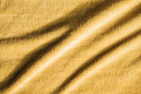 Full frame image of yellow crumpled terry fabric background — Stock Photo