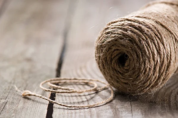 Selective focus of beige string on wooden background — Stock Photo