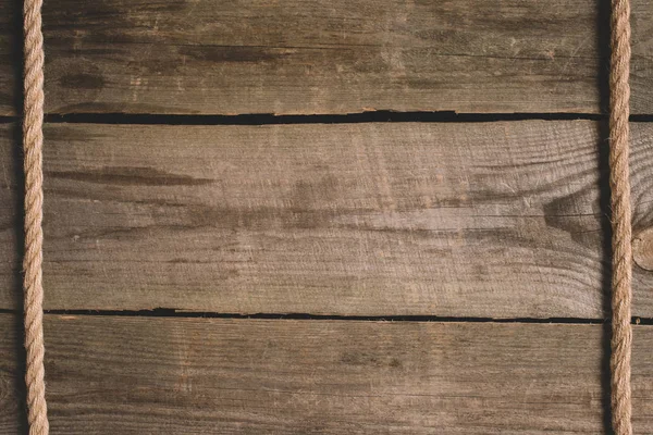 Elevated view of beige nautical rope on wooden background — Stock Photo