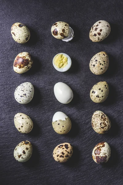 Top view of healthy boiled quail eggs on black background — Stock Photo