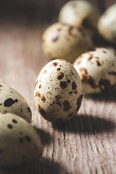 Close-up view of fresh organic quail eggs on wooden table — Stock Photo