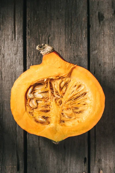 Top view of cut pumpkin half on wooden background — Stock Photo