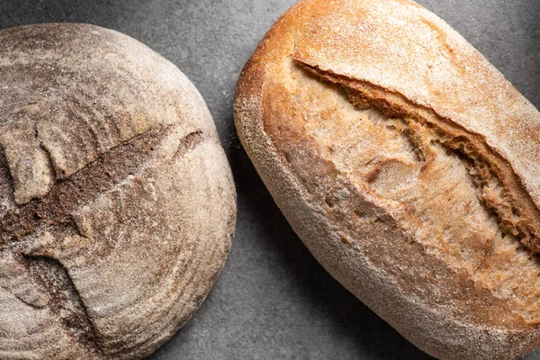 Top view of loafs of bread on grey tabletop — Stock Photo