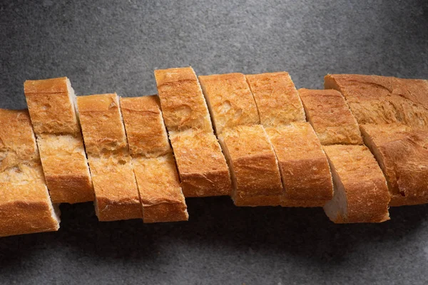 Draufsicht auf geschnittenes Baguette auf grauer Oberfläche — Stockfoto