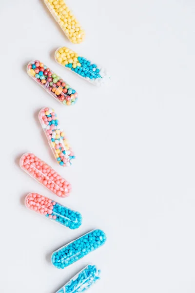 Top view of various colorful medical capsules on white — Stock Photo