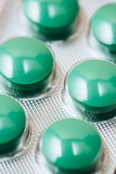 Close-up shot of blister with green pills — Stock Photo