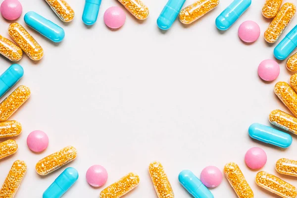Top view of frame made of various colorful pills on white surface — Stock Photo