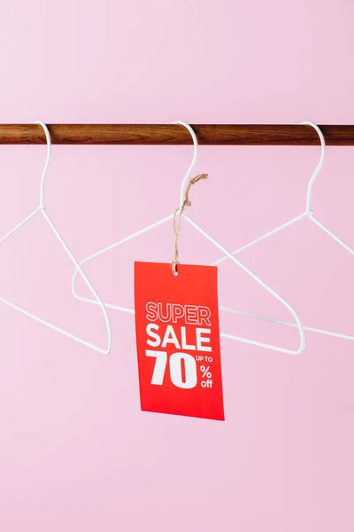 Hangers with red super sale tag - seventy percents discount on pink — Stock Photo