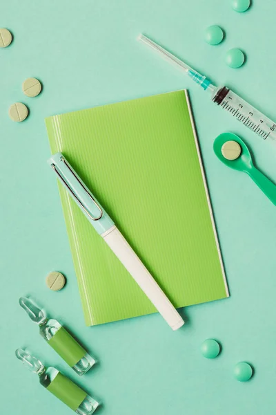 Top view of various medicines and medical tools on green — Stock Photo