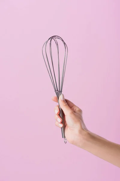 Cropped shot of woman holding whisk isolated on pink — Stock Photo
