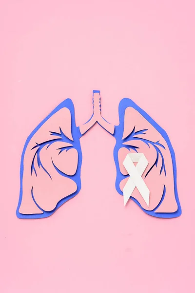 Flat lay with lung cancer awareness white ribbon and human lungs on pink — Stock Photo