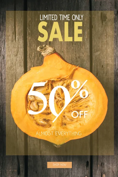 Top view of cut pumpkin half on wooden background with sale inscription — Stock Photo